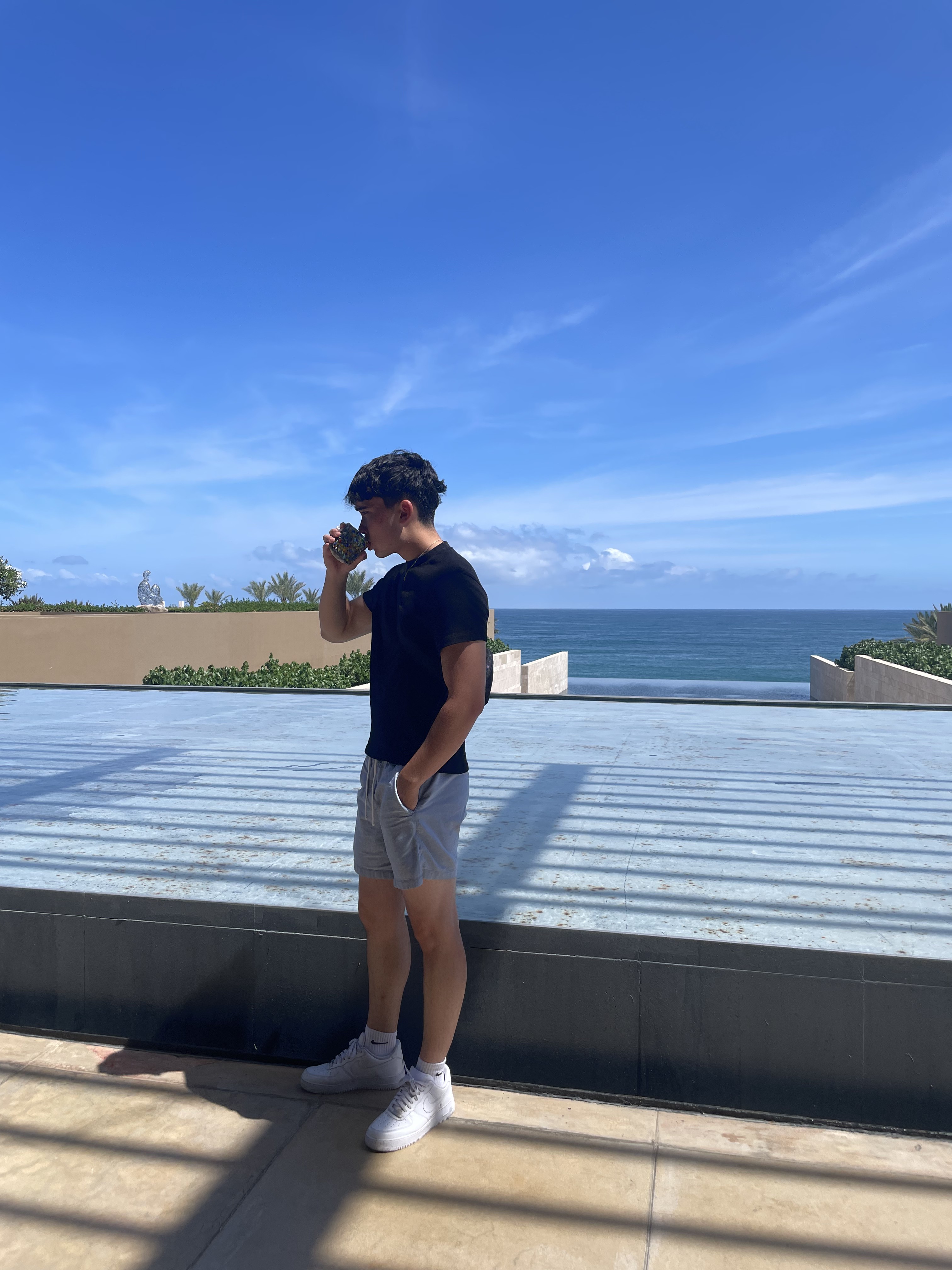 Tim standing by the ocean